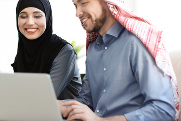 Wall Mural - Muslim businessman with coworker in office