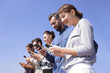 © ASDF - young people using smartphones to search network