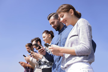 Wall Mural - young people using smartphones to search network