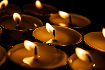 burning candles on black background