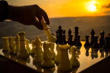 chess board game concept of business ideas and competition and strategy ideas. Chess figures on a chessboard outdoor sunset background.