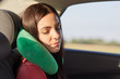 © sementsova321 - Beautiful female uses neck pillow for sleeping in car, has trip on long distance, trries to relax, feels pain in neck for being in one position much time. People, travelling, comfort, journey concept