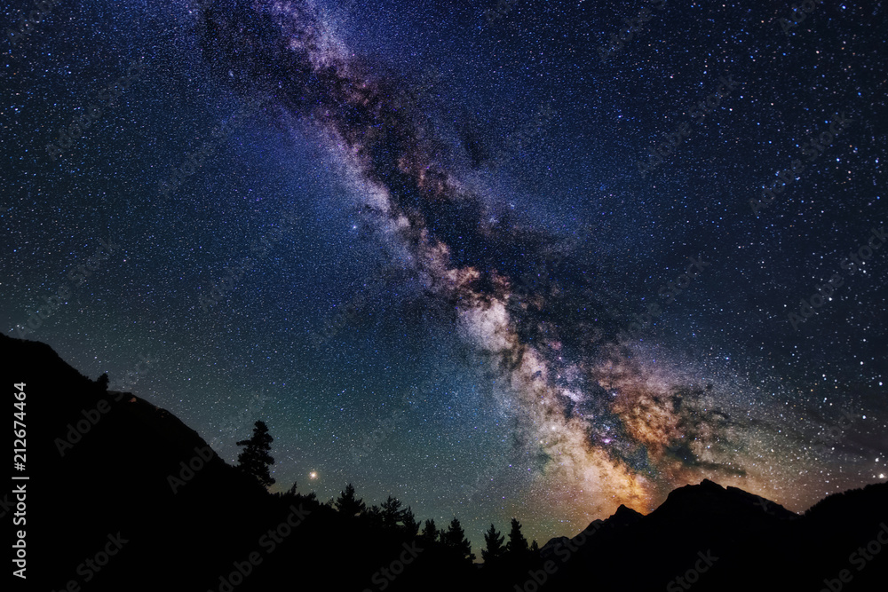 Astrophotography of Milky Way galaxy. Silhouette of mountains. Stars, nebula and stardust at night sky landscape - obrazy, fototapety, plakaty 
