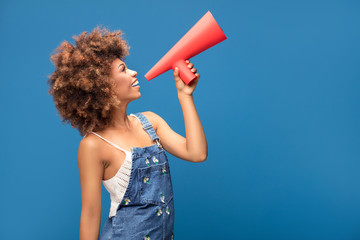afro young girl screaming by red megaphone.