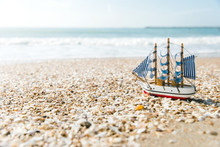 Ship Model On Summer Sunny Beach. Travel, Voyage, Vacation Concepts
