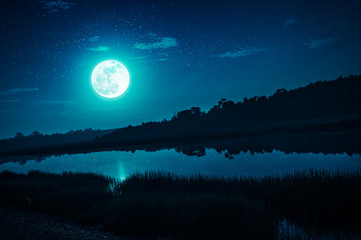 Wall Mural - night sky with full moon and many stars, serenity nature background.