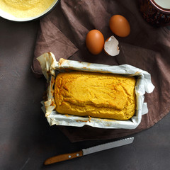 Wall Mural - Fresh loaf homemade corn bread dark background top view