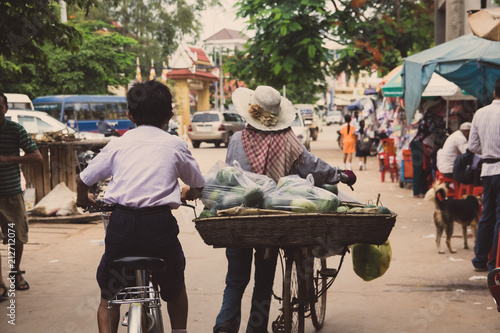 Cuadros en Lienzo hawker on bicycle in a market in cambodia