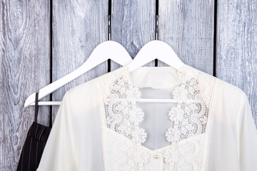 Wall Mural - Fashinable woman clothing collection. Close up white lace blouse on hanger.