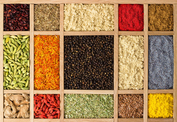 Wall Mural - Wooden box with Indian spices and herbs. Seasonings as a background for packaging with food.