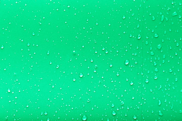 Drops of water on a color background. Green. Toned