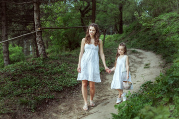 Wall Mural - Young mother with her daughter in the woods