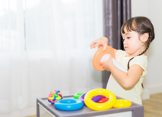 cute little children are playing toy while sitting on Living in home.kindergarten or nursery.preschool girl play on floor with education toy-blocks