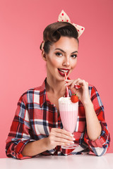 Poster - Portrait of a happy brunette pin-up girl in plaid shirt