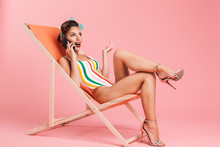Portrait Of A Cheerful Brunette Pin-up Girl In Swimsuit