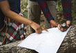 © Rawpixel.com - Trekking couple using map and compass in a forest