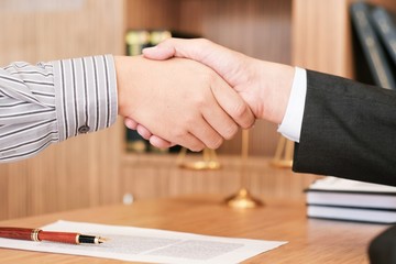 Female lawyer handshake with client. Business partnership meeting successful concept.