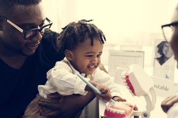 Wall Mural - Father and son meeting up with a dentist