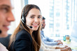 © Atstock Productions - Smiling friendly woman working in call center office with team as the customer care operators