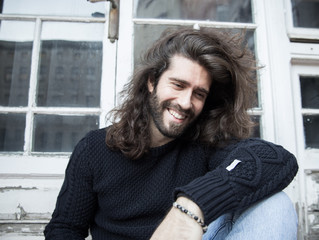 Wall Mural - Man with long hair and smiling portrait