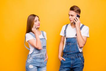 He and she jealous people concept. Close up photo portrait of handsome gentleman pretty lady holding cellular near ear listening to subscriber operator call center isolated bright background