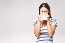 People, Healthcare, Rhinitis, Cold And Allergy Concept - Unhappy Woman With Paper Napkin Blowing Nose
