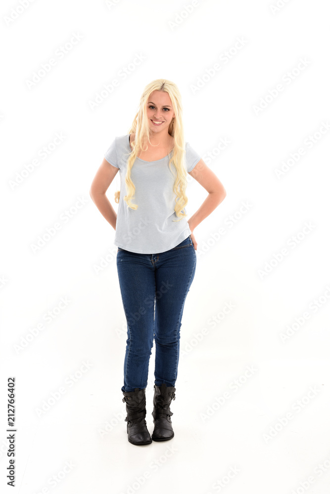 full length portrait of blonde girl wearing blue shirt and jeans ...