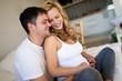 © NDABCREATIVITY - Happy pregnant woman relaxing with her husband