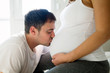 © NDABCREATIVITY - Happy pregnant woman relaxing with her husband