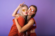Two young women are having fun and friends are hugging each other.Two happy affectionate young woman hugging each other in a close embrace while laughing and smiling, young multiracial female friends.