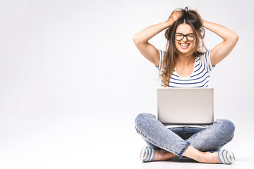 Wall Mural - Business concept. Portrait of depressed woman in casual sitting on floor in lotus pose and holding laptop isolated over white background. Using phone.