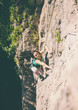 © zhukovvvlad - The woman climbs the rock.