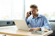 © Cressida studio - Stylish young man calling by the phone to solve business problems. Online consultation by phone. Freelancer discussing the development and planning of his online project. Outsourcing. Mobile services.