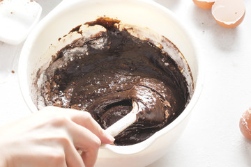 Mixing chocolate brownies batter 