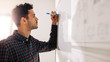 © Jacob Lund - Businessman writing on whiteboard in office
