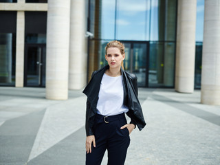 Trendy young businesswoman on street