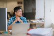 © mavoimages - Asian designer sitting at his desk deep in thought