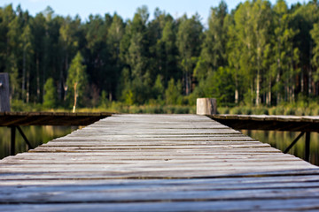 Pier, river and forest. View of the river and pier. Beautiful summer green view, landscape. Summer background.