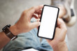 © bongkarn - Cropped shot of an unrecognizable man using a smart phone. Blank screen mobile phone for graphic display montage
