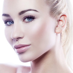 Beauty model girl face. Perfect skin, lips, blue eyes. Beautician patient. White background