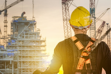 double exposure of construction worker wearing safety harness and safety line working