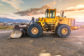 Wall Mural - Excavator at the end of a working day in a construction site