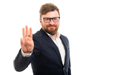 Wall Mural - Portrait of business man showing number three with fingers