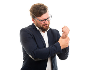 Wall Mural - Portrait of business man showing wrist pain gesture.