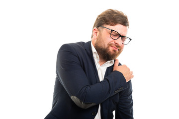 Wall Mural - Portrait of business man showing shoulder pain gesture.
