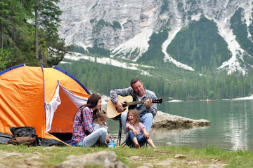 portrait of a happy family while they are having a good day at the lake. concept: love, holiday, mus