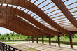 massive wood beams roof structure with S curved shaped and covered with transparent polycarbonate sheet