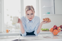 Young Elegant Lovely Charming Clever Attractive Adorable Smiling Woman Office Executive Worker Wearing Spectacles Reading Newspaper Early In The Morning Having A Drink And Croissant In Kitchen