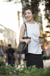© Blue Jean Images - Confident young Chinese businesswoman holding  a cup of coffee