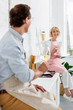 © LIGHTFIELD STUDIOS - happy senior couple holding glasses of wine and smiling at camera while cooking together